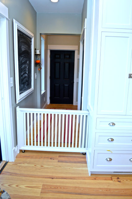 When customizing our cabinets, we worked with our cabinet builder to create a built-in hidden dog gate, perfect for our family!