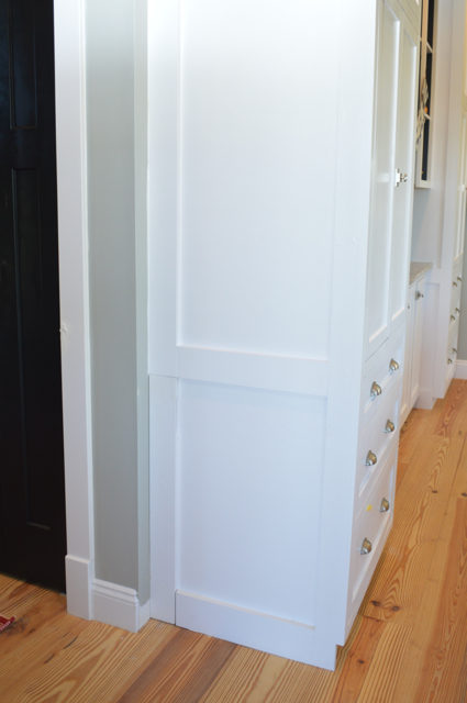 When customizing our cabinets, we worked with our cabinet builder to create a built-in hidden dog gate, perfect for our family!