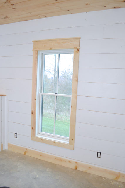 installing DIY shiplap walls and farmhouse trim from wood flooring