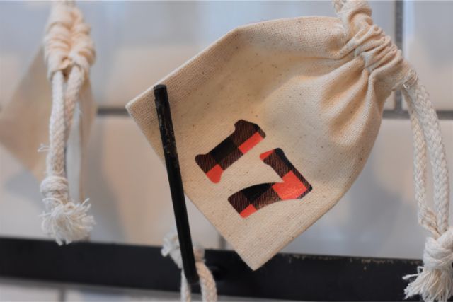 Small canvas bags hold treats and activities to do for Advent.